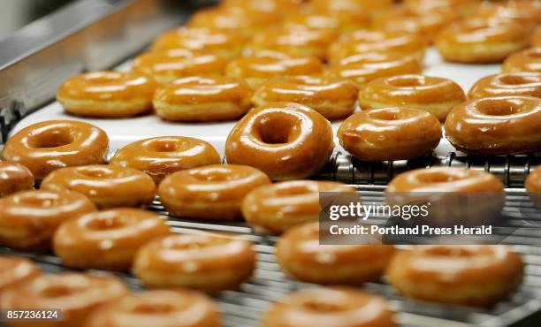 Donuts on the 270 machine at Krispy Kreme in Saco Tuesday, October 3, 2017. The 270 machine makes 270 dozen donuts per hour.