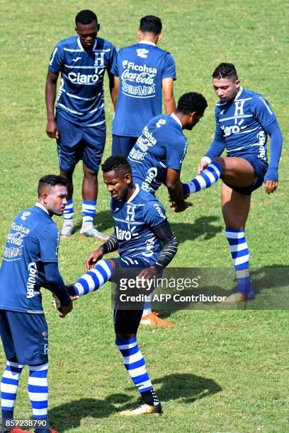 Honduras football team players stretch during a training session at the Carlos Miranda stadium, in Comayagua, 80 km north of Tegucigalpa, on October...
