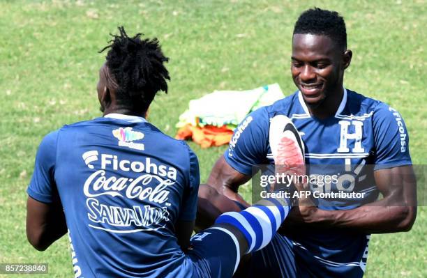 Honduras' players Mynor Figueroa and Albert Elis stretch during a training session at the Carlos Miranda stadium, in Comayagua, 80 km north of...