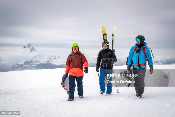 backcountry skier and snowboarders on mountain summit - off piste stock pictures, royalty-free photos & images