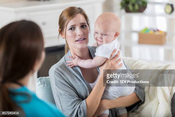 concerned mom talks with pediatrician about her daughter's health. - visit stock pictures, royalty-free photos & images