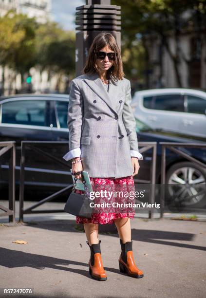 Natasha Goldenberg wearing grey checked blauer, red skirt seen outside Miu Miu during Paris Fashion Week Spring/Summer 2018 on October 3, 2017 in...