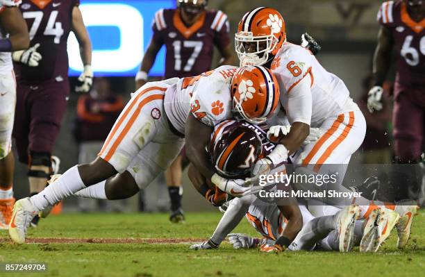 Linebacker Kendall Joseph and linebacker Dorian O'Daniel of the Clemson Tigers combine to tackle running back Deshawn McClease of the Virginia Tech...