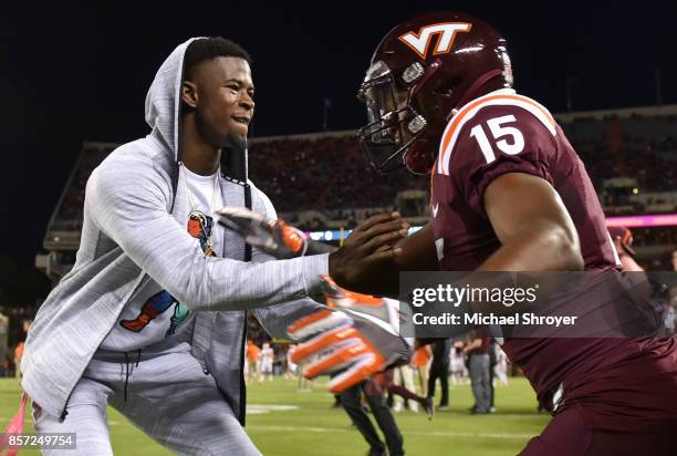 Former wide receiver Isaiah Ford of the Virginia Tech Hokies warms up with wide receiver Sean Savoy prior to the game against the Clemson Tigers at...