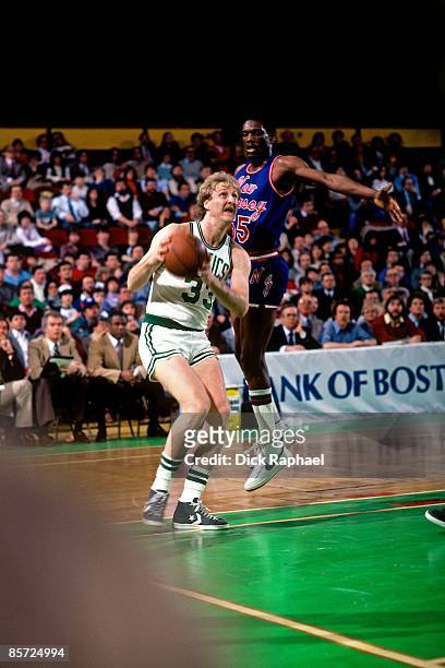 Larry Bird of the Boston Celtics takes the ball to the basket against Albert King of the New Jersey Nets during a game played in 1982 at the Boston...