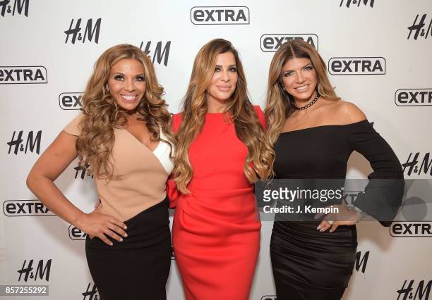 Television personalities Dolores Catania, Siggy Flicker and Teresa Giudice visit "Extra" at H&M Times Square on October 3, 2017 in New York City.