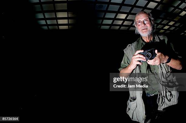 Czech photographer Josef Koudelka plays with his camera during the opening of the exhibition 'Invasion Prague 68' at the Tlatelolco Cultural Center...
