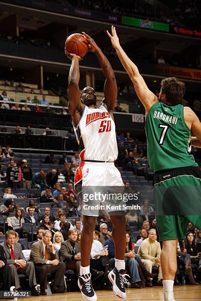 Emeka Okafor of the Charlotte Bobcats shoot a jump shot over Andrea Bargnani of the Toronto Raptors during the game at Time Warner Cable Arena on...