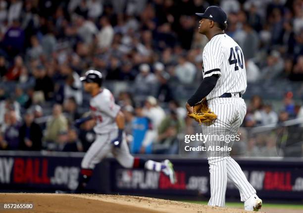 Luis Severino of the New York Yankees reacts as Eddie Rosario of the Minnesota Twins rounds the bases after hitting a two run home run during the...