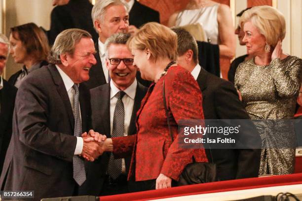 Former German chancellor Gerhard Schroeder and German chancellor Angela Merkel during the Re-Opening of the Staatsoper Unter den Linden on October 3,...