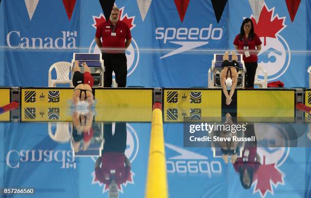 Tess Routliffe and Justine Morrier of Canada start the 100 metres breaststroke as the Para-swimming athletes compete in the Para-Swimming Canadian...