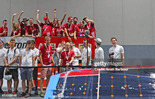 Team members celebrate as RED Shift, the car from the Netherlands Solar Team Twente passes testing during Static Scrutineering before competing in...