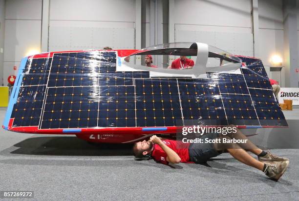 Team member works on the car as RED Shift, the car from the Netherlands Solar Team Twente is tested during Static Scrutineering before competing in...