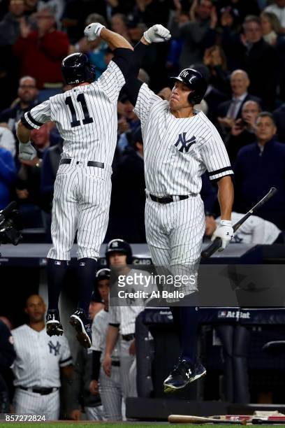 Brett Gardner of the New York Yankees celebrates with teammate Aaron Judge after hitting a home run against Ervin Santana of the Minnesota Twins...