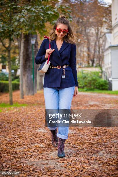 Angelica Ardasheva wearing Maryling jacket, Maxco vintage sunglasses, Levis 501 pants, Mellow Yellow boots and Gucci bag is seen after the Moncler...