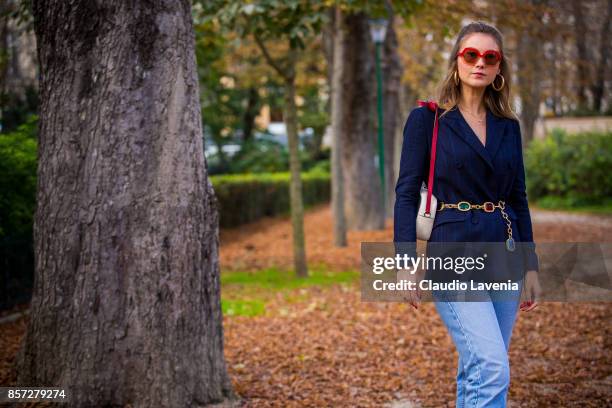 Angelica Ardasheva wearing Maryling jacket, Maxco vintage sunglasses, Levis 501 pants and Gucci bag is seen after the Moncler Gamme Rouge show during...