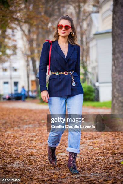 Angelica Ardasheva wearing Maryling jacket, Maxco vintage sunglasses, Levis 501 pants, Mellow Yellow boots and Gucci bag is seen after the Moncler...