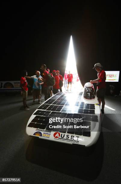 Team members look on as Lumen II, the car from Australia's Adelaide University Solar Racing Team is tested during Static Scrutineering before...