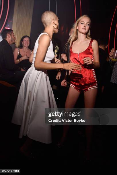 Adwoa Aboah and a guest attend the Miu Miu aftershow party as part of the Paris Fashion Week Womenswear Spring/Summer 2018 at Boum Boum on October 3,...