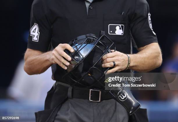 Home plate umpire Mark Wegner holds his mask during the Toronto Blue Jays MLB game against the Kansas City Royals at Rogers Centre on September 20,...