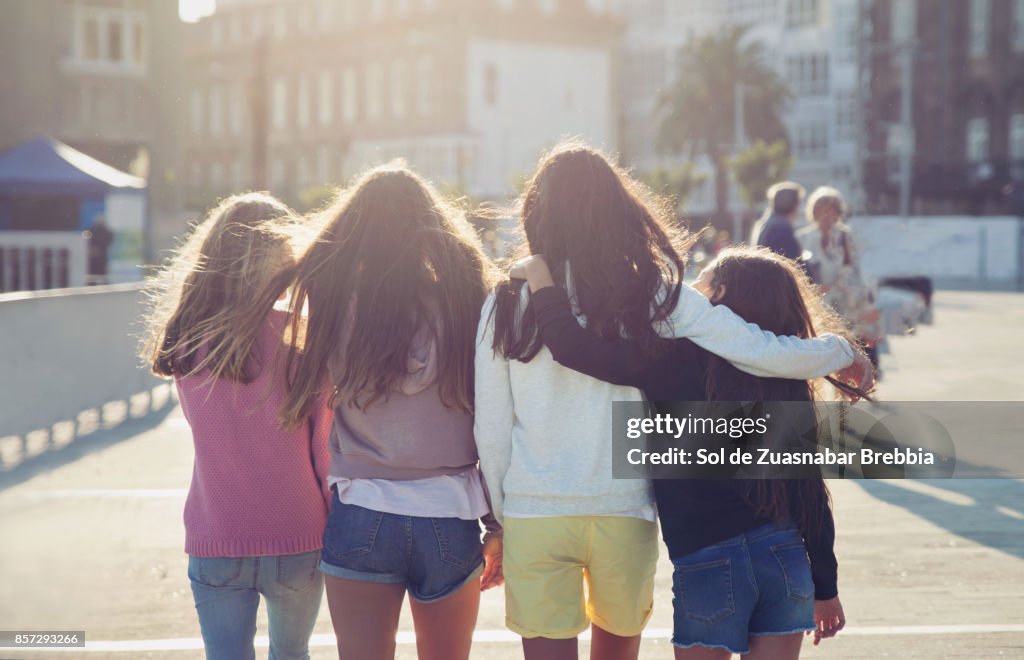 Teen girls walking together on a beautiful sunny day.