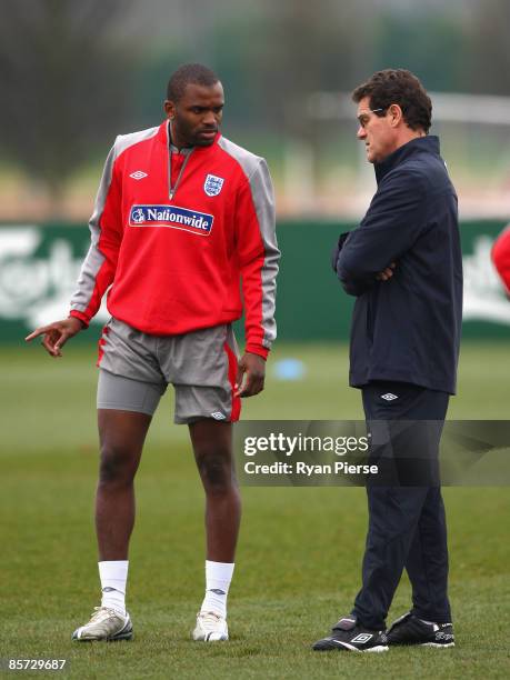 Darren Bent of England speaks to Fabio Capello , manager of England, about his injury during an England Training Session at the Arsenal Training...