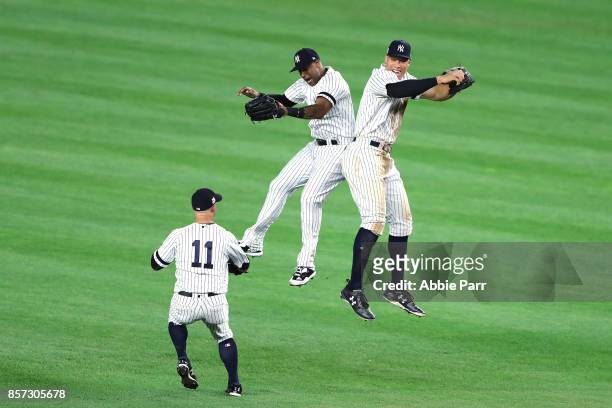 Aaron Judge of the New York Yankees celebrates with Aaron Hicks and Brett Gardner after defeating the Minnesota Twins in the American League Wild...