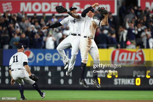 Aaron Judge of the New York Yankees celebrates with Aaron Hicks and Brett Gardner after defeating the Minnesota Twins in the American League Wild...