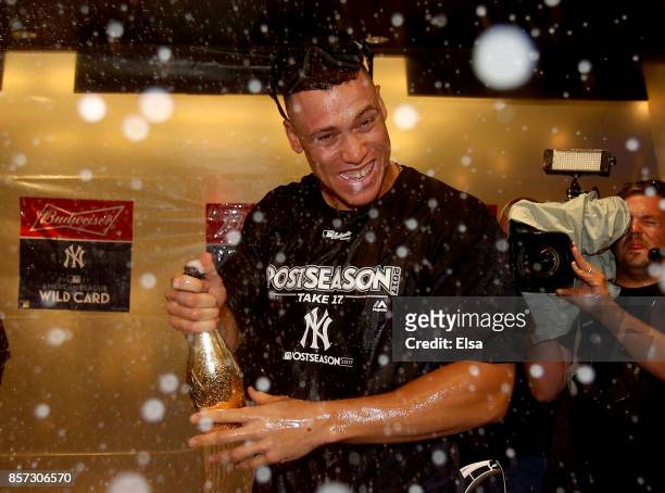 Aaron Judge of the New York Yankees celebrates in the clubhouse after defeated the Minnesota Twins during the American League Wild Card Game at...