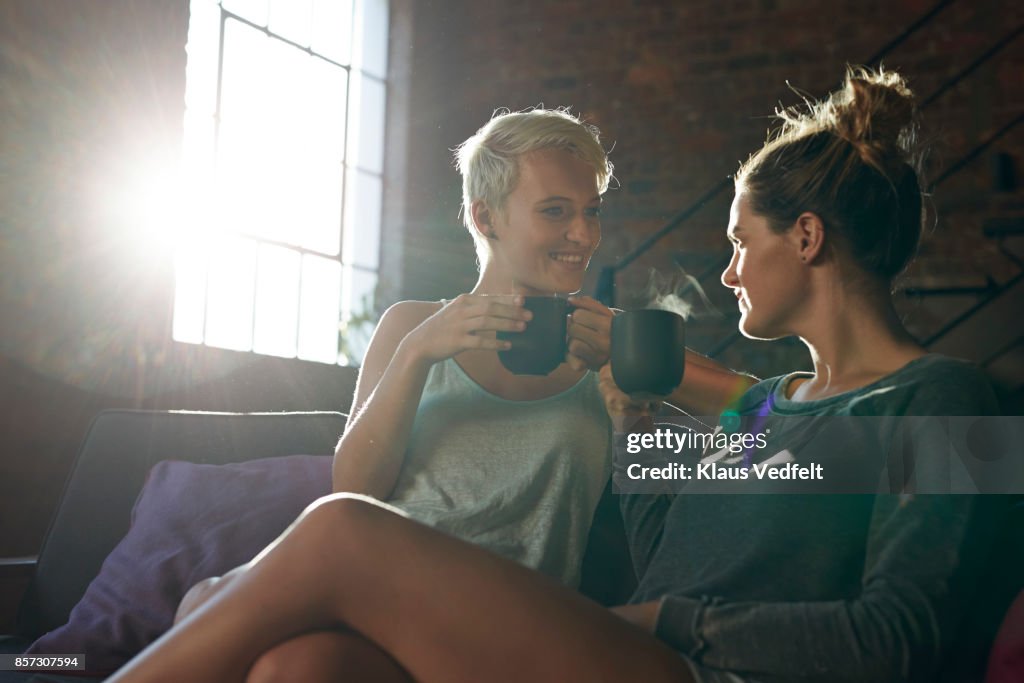 Lesbian couple relaxing and drinking tea