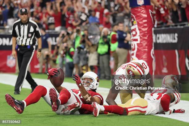 Wide receiver Larry Fitzgerald of the Arizona Cardinals reacts after scoring the game winning touchdown over cornerback Rashard Robinson and...