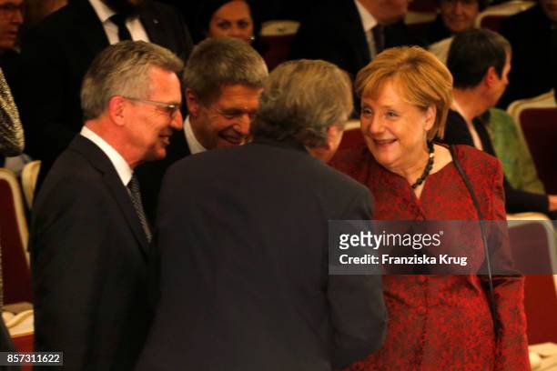 German Interior Minister Thomas de Maiziere, Joachim Sauer, Former German chancellor Gerhard Schroeder and German Chancellor Angela Merkel attend the...