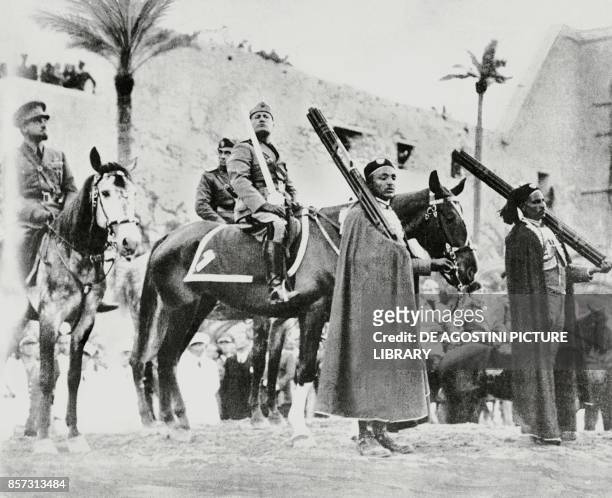 Benito Mussolini on horseback holding the sword of Islam in Tripoli, with Italo Balbo on the left, Libya, from L'Illustrazione Italiana, March 28,...