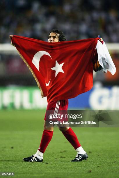 Bulent Korkmaz of Turkey celebrates victory after the FIFA World Cup Finals 2002 Quarter Finals match between Senegal and Turkey played at the...