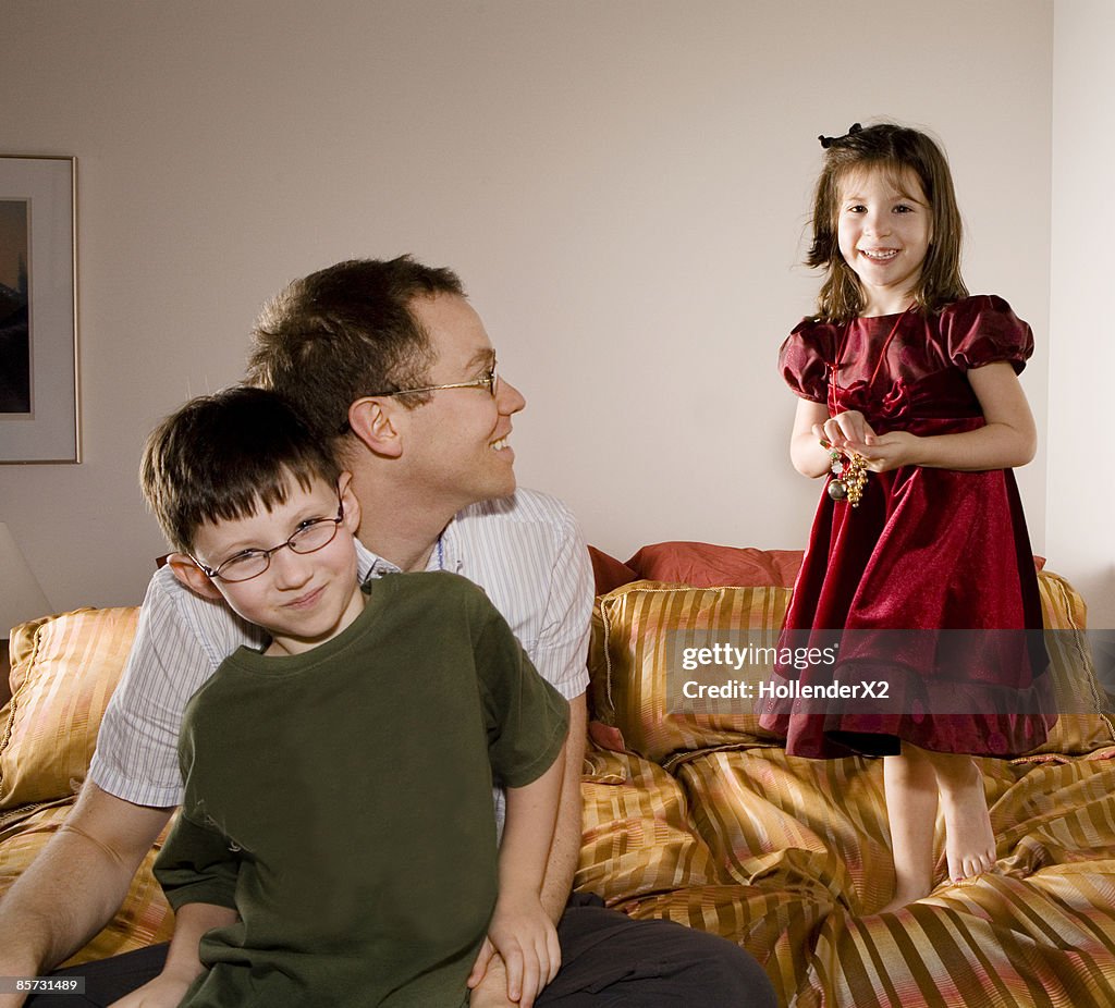 Man with kids on bed