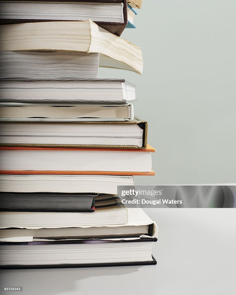 Pile of books on table.