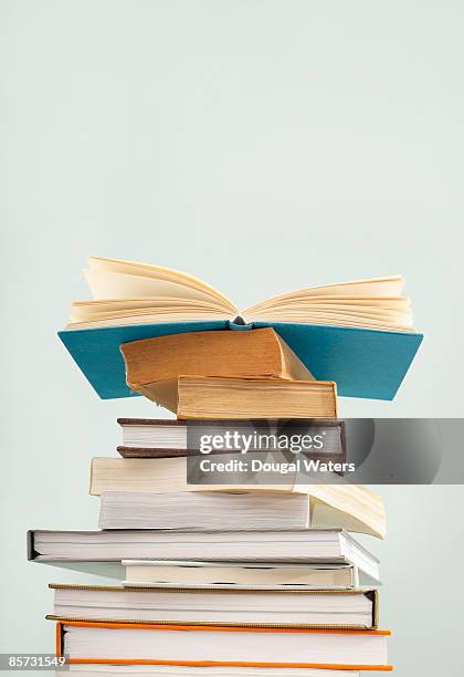 books piled up. - pile of books stock-fotos und bilder