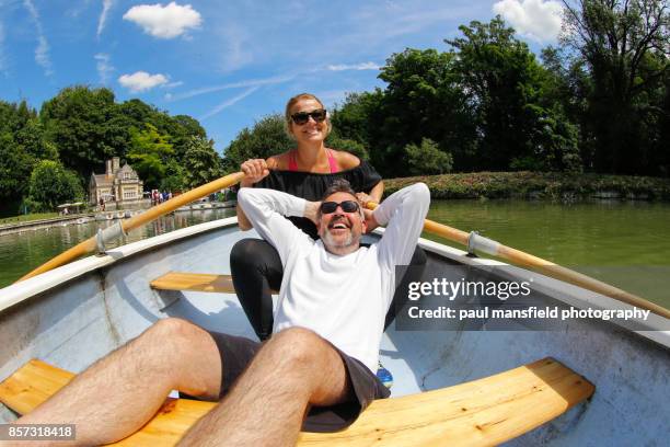 mature heterosexual couple on rowing boat - mid adult stock pictures, royalty-free photos & images
