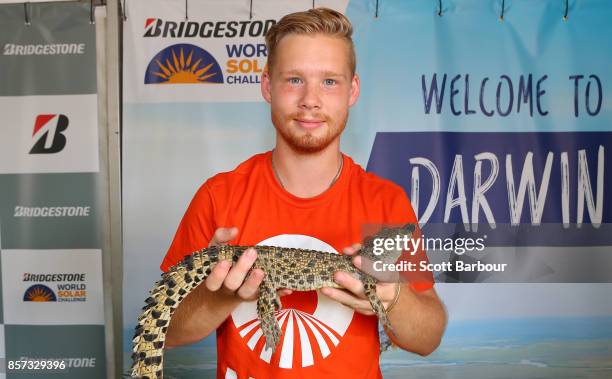 Leo Thorsell-Skog, team member of MDH Solar Car, the car from Sweden's MDH Solar Team poses with a saltwater crocodile at the Bridgestone 'Hub'...