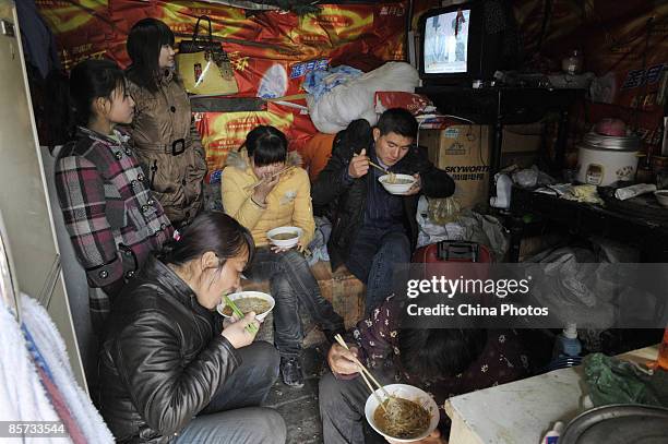 People who collect recyclable waste have lunch in a shanty at the Zhangshi Village on March 20, 2009 in Shenyang of Liaoning Province, China. More...