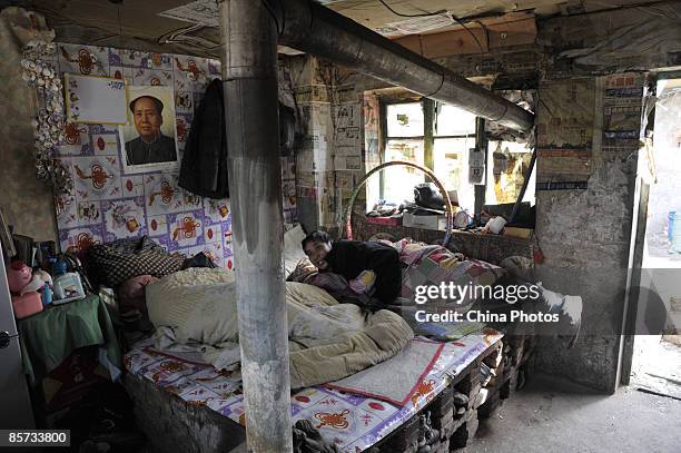 Man who collects recyclable waste rests in a shanty at the Zhangshi Village on March 20, 2009 in Shenyang of Liaoning Province, China. More and more...