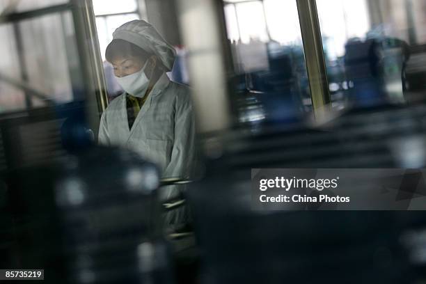 Worker inspects barreled water at a purified drinking water factory on March 21 on the eve of World Water Day, in Xian of Shaanxi Province, China....