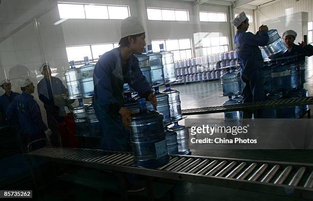 Workers transport barreled water at a purified drinking water factory on March 21 on the eve of World Water Day, in Xian of Shaanxi Province, China....