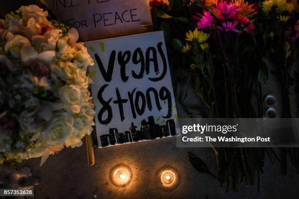 Flowers and signs are seen at a vigil that was held for the victims along the Las Vegas Strip a day after 59 people were killed and more than 500...