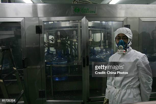 Worker labours at a purified drinking water factory on March 21 on the eve of World Water Day, in Xian of Shaanxi Province, China. China feeds 21...