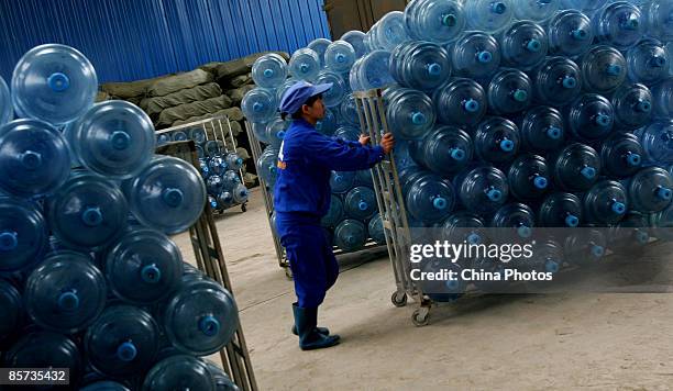 Worker transports barrels at a purified drinking water factory on March 21 on the eve of World Water Day, in Xian of Shaanxi Province, China. China...