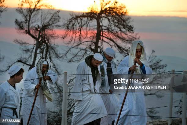 Samaritans walk up to pray on Mount Gerizim, near the northern West Bank city of Nablus, during celebrations for the holiday of Sukkot , which marks...