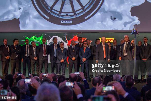 Marco Tronchetti Provera, chief executive officer of Pirelli & C. SpA, right, rings the opening bell, as part of the Pirelli & C. SpA launch...