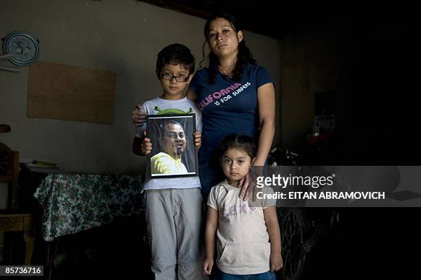 Guatemalan photojournalist Doriam Morales poses at home with her sons Diego and Sofia in Guatemala City on March 21, 2009. On October 22 Morales�...