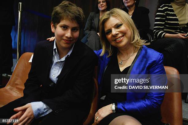 Sara Netanyahu, wife of incoming Israeli premier Benjamin Netanyahu, and their younger son Avner, attend the swearing-in session of the new coalition...